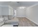Open-concept living room with modern lighting, light gray walls and light-colored wood flooring at 2340 Beaver Ruin Rd # Un62, Norcross, GA 30071