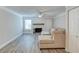 Open-concept living room with fireplace, ceiling fan, and neutral-toned sectional at 2340 Beaver Ruin Rd # Un62, Norcross, GA 30071