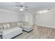 Spacious living room with light gray walls, modern ceiling fan and light-colored wood flooring at 2340 Beaver Ruin Rd # Un62, Norcross, GA 30071