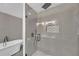 Modern bathroom featuring a glass shower, soaking tub, and gray tiled walls at 2769 Glenwood Se Ave, Atlanta, GA 30317