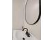 A modern bathroom features a white sink, black hardware, and an oval mirror at 2769 Glenwood Se Ave, Atlanta, GA 30317