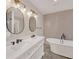 A modern bathroom features a double sink vanity, soaking tub, and modern fixtures at 2769 Glenwood Se Ave, Atlanta, GA 30317