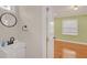 Bathroom vanity with a round mirror; the doorway leads into the bedroom at 2769 Glenwood Se Ave, Atlanta, GA 30317