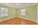 Spacious bedroom with hardwood floors, neutral walls, and natural light from windows at 2769 Glenwood Se Ave, Atlanta, GA 30317