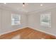 Empty bedroom with hardwood floors, two windows, and recessed lighting at 2769 Glenwood Se Ave, Atlanta, GA 30317