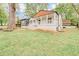 Charming home featuring a quaint covered porch, gray siding and freshly painted white brick at 2769 Glenwood Se Ave, Atlanta, GA 30317