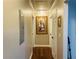 Hallway with hardwood floors, white trim and doors, recessed lighting, and decorative art at 2769 Glenwood Se Ave, Atlanta, GA 30317