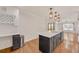 An open-concept kitchen features a center island, modern lighting, stainless steel appliances, and hardwood floors at 2769 Glenwood Se Ave, Atlanta, GA 30317