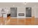 Open-concept living area with modern fireplace, hardwood floors, and seamless flow to the kitchen at 2769 Glenwood Se Ave, Atlanta, GA 30317
