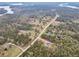 Expansive aerial view of a property nestled amongst trees, near a picturesque lake at 3911 Peeksville Rd, Locust Grove, GA 30248