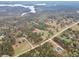 Gorgeous aerial view of property in a wooded area near a beautiful, sprawling lake at 3911 Peeksville Rd, Locust Grove, GA 30248