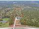 Aerial view of a gorgeous property outlined in red, surrounded by a dense forest of mature trees at 3911 Peeksville Rd, Locust Grove, GA 30248