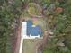 Top-down aerial view of the home, showcasing the roofline, yard and surrounding wooded area at 3911 Peeksville Rd, Locust Grove, GA 30248