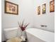 Bathroom displaying a modern bathtub and toilet with decorative wall art and elegant floral accents at 3911 Peeksville Rd, Locust Grove, GA 30248