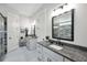 Modern bathroom featuring granite countertops, double sinks, a walk-in shower, and updated fixtures at 3911 Peeksville Rd, Locust Grove, GA 30248
