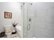 Bathroom features a glass enclosed shower with decorative tile, a modern bathtub, and elegant floral accents at 3911 Peeksville Rd, Locust Grove, GA 30248