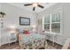 Inviting bedroom with a charming beach theme, featuring coral bedding, nautical decor, and a well-lit desk at 3911 Peeksville Rd, Locust Grove, GA 30248