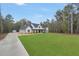 Beautiful modern farmhouse with a sprawling front lawn and a long driveway at 3911 Peeksville Rd, Locust Grove, GA 30248