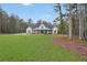 Spacious modern farmhouse with a large front yard and inviting covered front porch at 3911 Peeksville Rd, Locust Grove, GA 30248