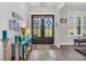 Welcoming foyer with double doors, stylish decor, and wood-look floors at 3911 Peeksville Rd, Locust Grove, GA 30248