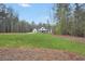 Modern farmhouse on a large, grassy lot surrounded by tall trees, offering privacy at 3911 Peeksville Rd, Locust Grove, GA 30248