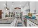 Spacious kitchen with a granite island, stainless appliances, and modern lighting at 3911 Peeksville Rd, Locust Grove, GA 30248