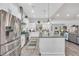 Open kitchen with a large island, stainless steel refrigerator, and wood floors at 3911 Peeksville Rd, Locust Grove, GA 30248
