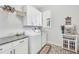 Well-organized laundry room with modern appliances, overhead cabinets, and stylish decor at 3911 Peeksville Rd, Locust Grove, GA 30248