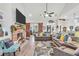 Open-concept living room with vaulted ceilings, fireplace, and views of the backyard at 3911 Peeksville Rd, Locust Grove, GA 30248
