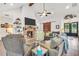 Spacious living room with a fireplace, ceiling fan, and natural light at 3911 Peeksville Rd, Locust Grove, GA 30248