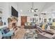 Comfortable living room with brick fireplace, vaulted ceiling, and wood-look flooring at 3911 Peeksville Rd, Locust Grove, GA 30248