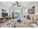 Spacious main bedroom featuring a ceiling fan, large windows, and a comfortable seating area at 3911 Peeksville Rd, Locust Grove, GA 30248
