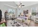 Bright main bedroom with a ceiling fan, large windows, and comfortable seating area at 3911 Peeksville Rd, Locust Grove, GA 30248