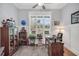 Inviting home office with a ceiling fan, a large window offering natural light, and classic decor at 3911 Peeksville Rd, Locust Grove, GA 30248