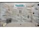 Modern bathroom shower featuring textured gray tiling, glass enclosure, and contemporary fixtures at 3911 Peeksville Rd, Locust Grove, GA 30248
