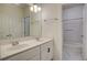 Well-lit bathroom featuring double sinks, quartz countertops and a shower-tub combo with marble flooring at 3769 Baxley Point Dr, Suwanee, GA 30024