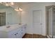 Bright bathroom featuring double sinks, large mirror and glass shower doors at 3769 Baxley Point Dr, Suwanee, GA 30024