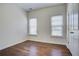 Cozy bedroom with natural light from two windows and hardwood flooring for a comfortable living space at 3769 Baxley Point Dr, Suwanee, GA 30024