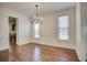 Elegant dining room featuring hardwood floors, wainscoting, and a stylish chandelier at 3769 Baxley Point Dr, Suwanee, GA 30024