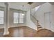 Open floor plan dining room with hardwood floors and staircase view at 3769 Baxley Point Dr, Suwanee, GA 30024