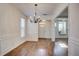 Bright dining room with hardwood floors, decorative wainscoting, and an entry to the home at 3769 Baxley Point Dr, Suwanee, GA 30024