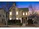 Charming two-story home with stone accents, mature landscaping and covered front entry at dusk at 3769 Baxley Point Dr, Suwanee, GA 30024