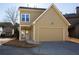 Residential house with large garage door, two-story exterior, and well-kept landscaping at 3769 Baxley Point Dr, Suwanee, GA 30024