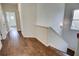 Hallway with gleaming hardwood floors, leading to rooms with natural light at 3769 Baxley Point Dr, Suwanee, GA 30024
