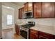 Well-equipped kitchen with stainless steel appliances and ample counter space at 3769 Baxley Point Dr, Suwanee, GA 30024
