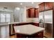Open kitchen design with stainless steel appliances, island, and staircase at 3769 Baxley Point Dr, Suwanee, GA 30024