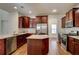 Modern kitchen boasts stainless steel appliances, a central island, and ample counter space at 3769 Baxley Point Dr, Suwanee, GA 30024