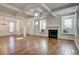 Spacious living area featuring hardwood floors, built-in window seats, and a fireplace at 3769 Baxley Point Dr, Suwanee, GA 30024