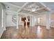 Open-concept living and dining areas with hardwood floors, coffered ceilings, and abundant natural light at 3769 Baxley Point Dr, Suwanee, GA 30024
