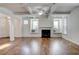 Spacious living area featuring hardwood floors, built-in window seats, and a fireplace at 3769 Baxley Point Dr, Suwanee, GA 30024
